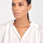 14k White Gold White Enamel Sideways Cross Necklace on woman's neck